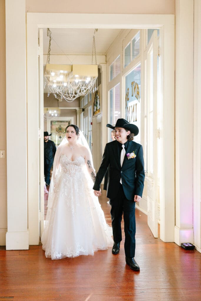 Bride and groom enter their wedding reception at Ant Street Inn in Brenham, Texas, following their outdoor garden ceremony.