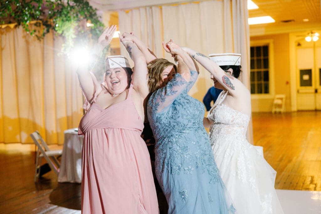 Bride and family members celebrate on the dance floor with Blue Bell ice cream hats during a wedding reception in Brenham, Texas, home of Blue Bell Creameries.