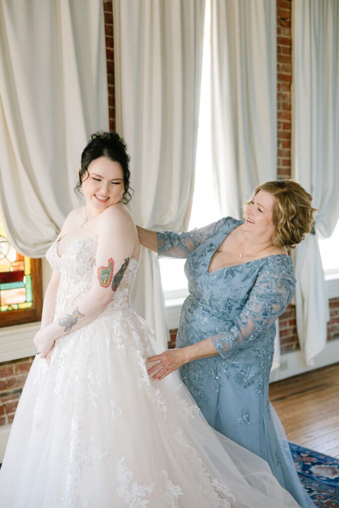 Mother of the bride shares a special getting-ready moment with her daughter before their wedding ceremony at Ant Street Inn in Brenham, Texas.